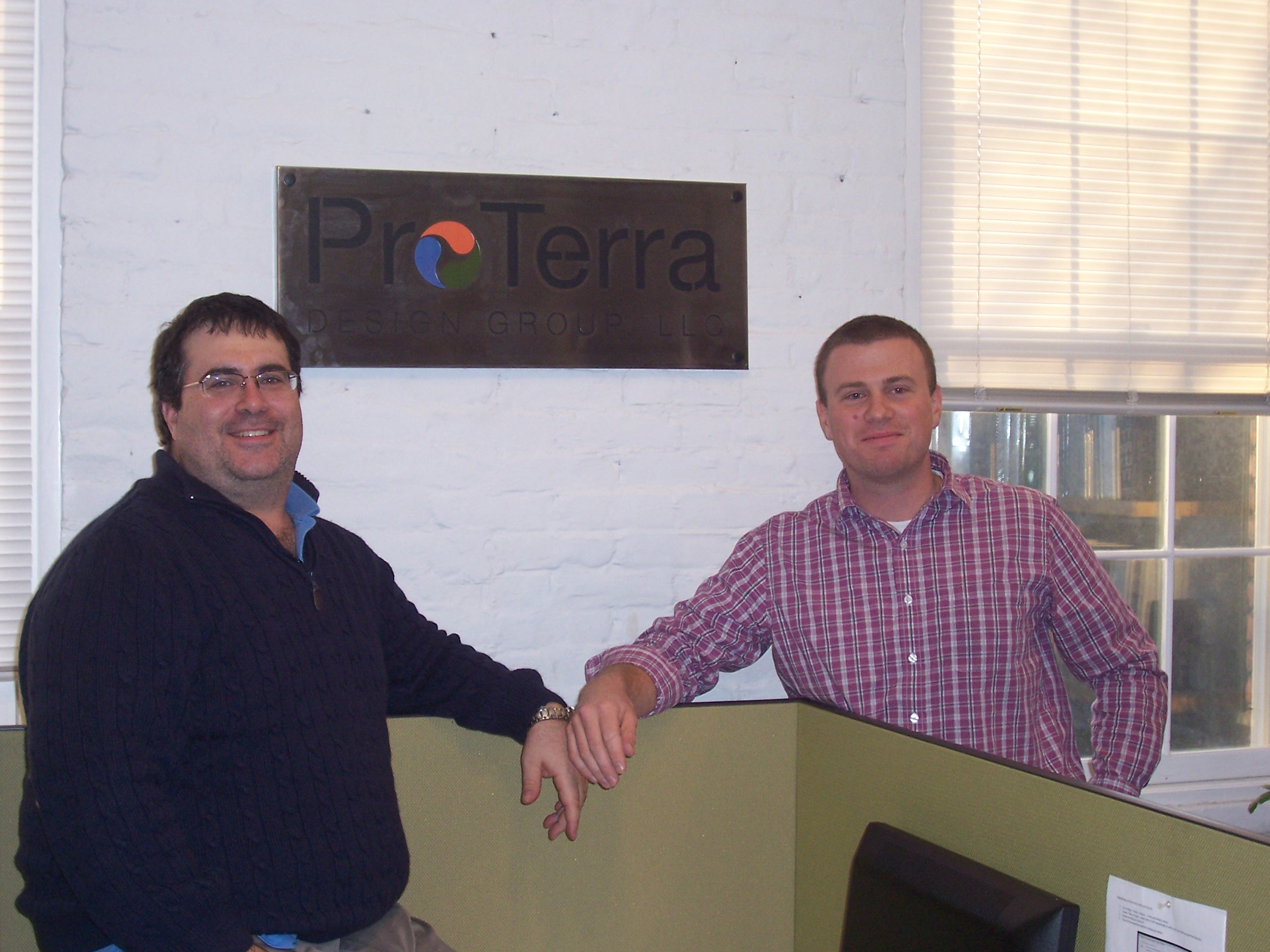 Two men in office by ProTerra sign