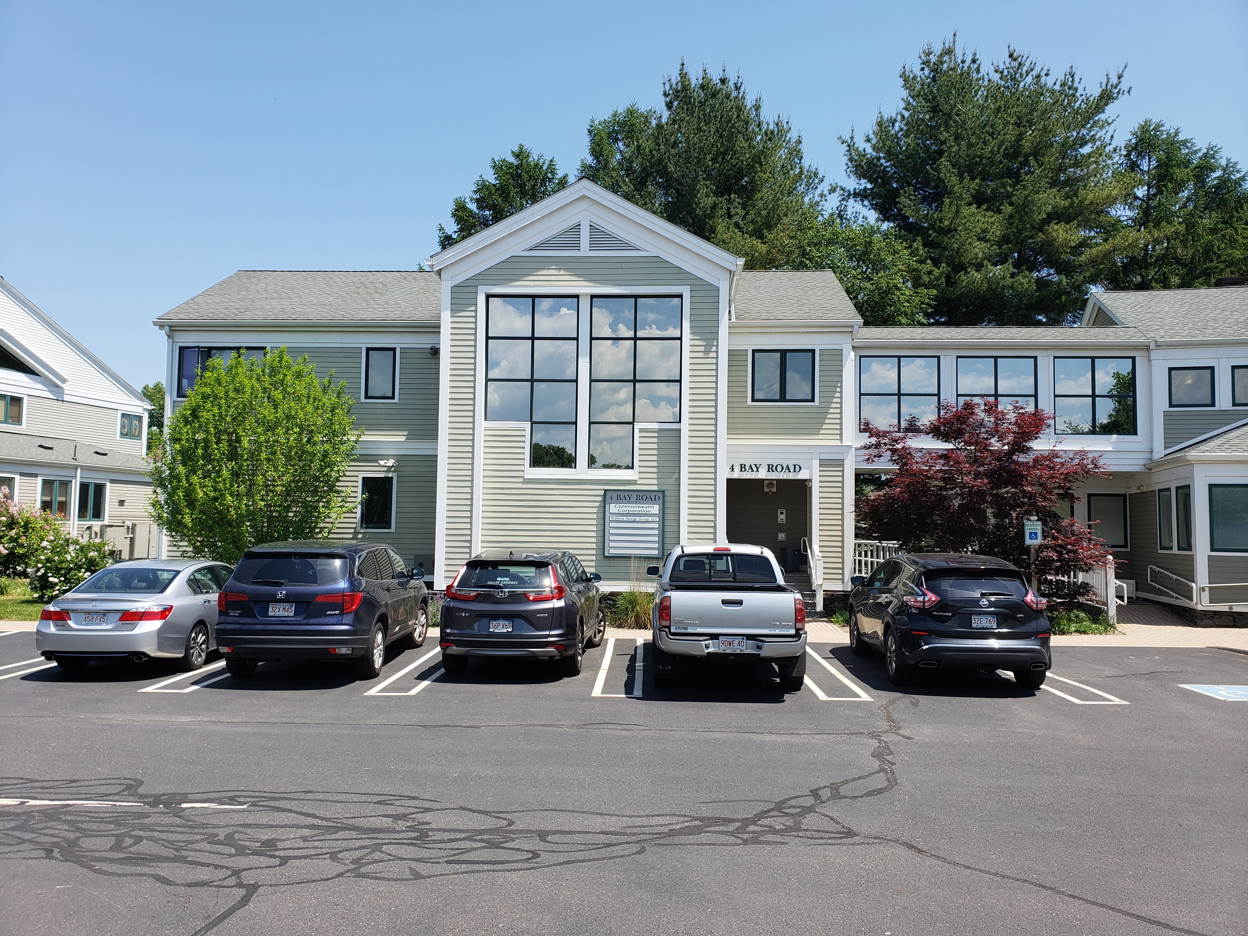 Two-story office building with parked cars