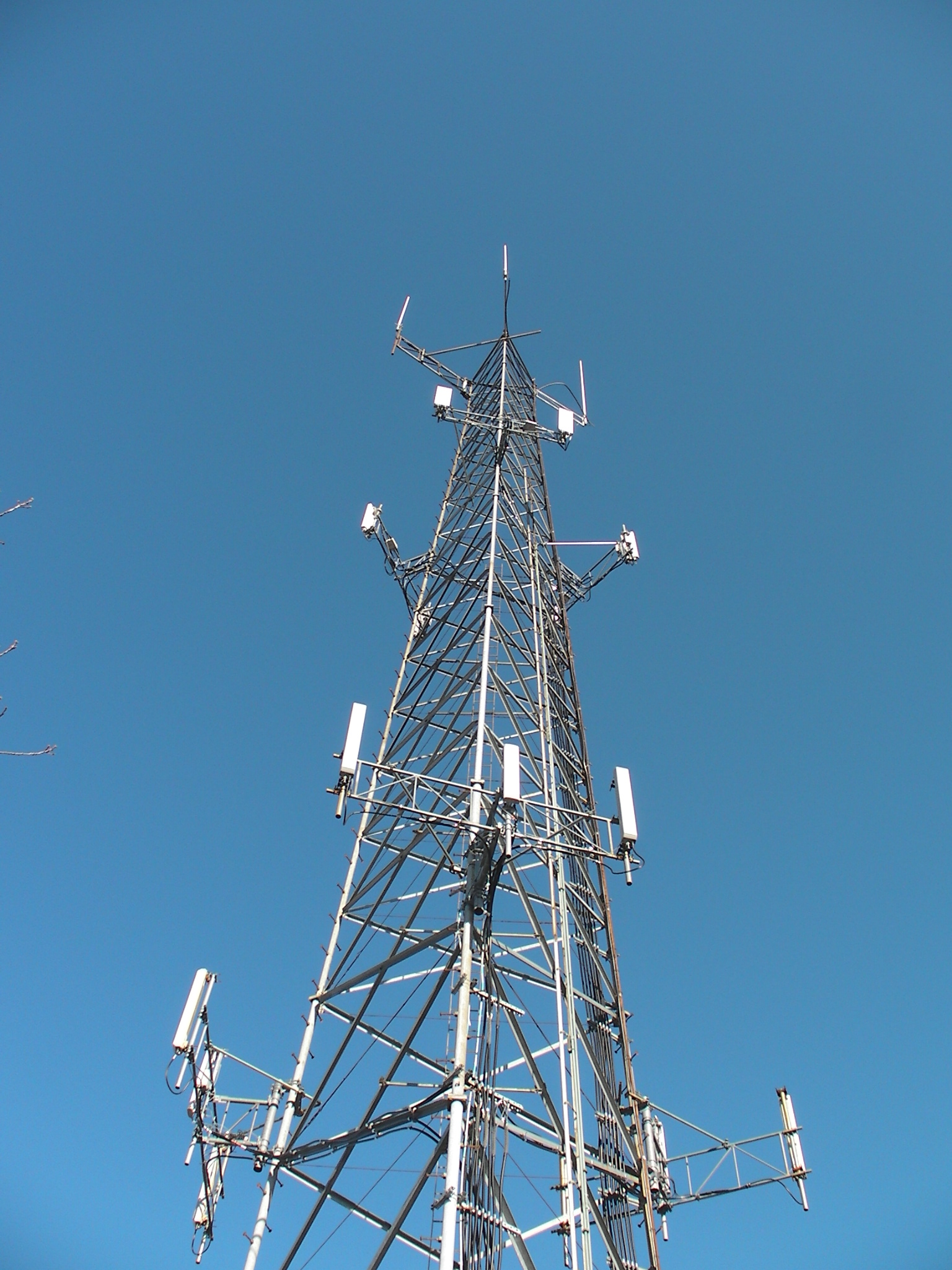 Cell tower against clear blue sky