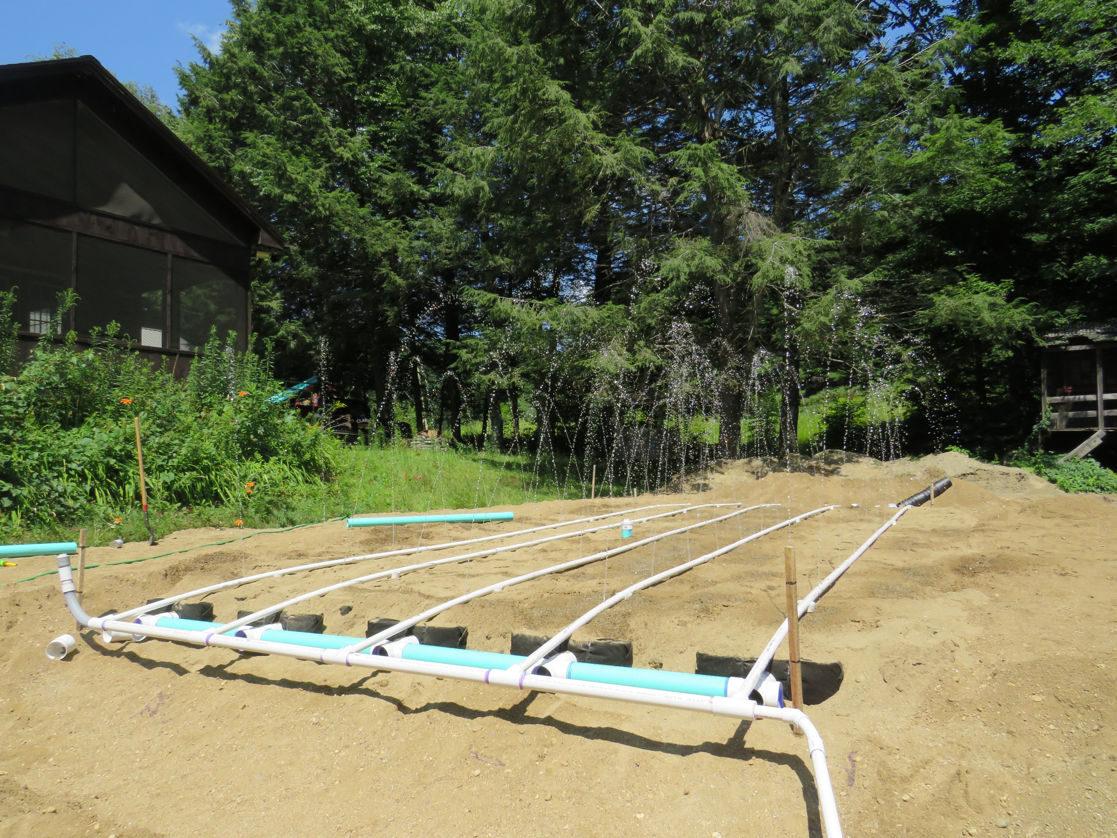 PVC irrigation lines laid across garden bed