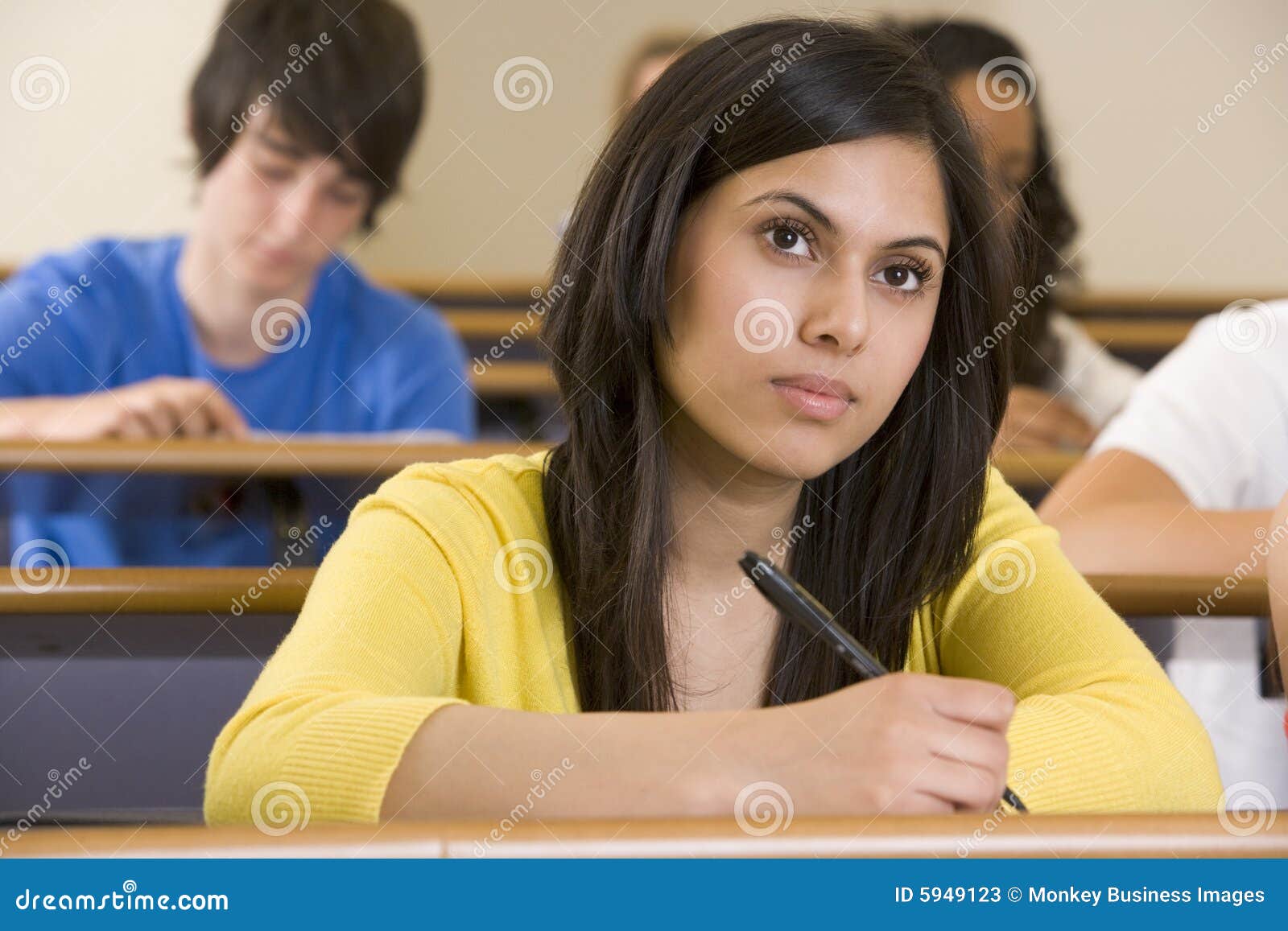 Student attentively taking notes in lecture