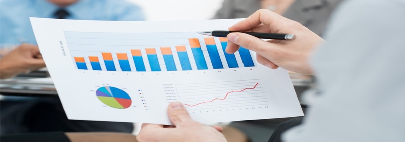 Hands holding business report with charts